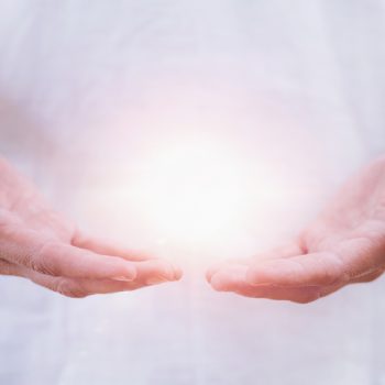 Close up horizontal image of distance healing hands of therapist at Reiki healing treatment. Alternative therapy concept
